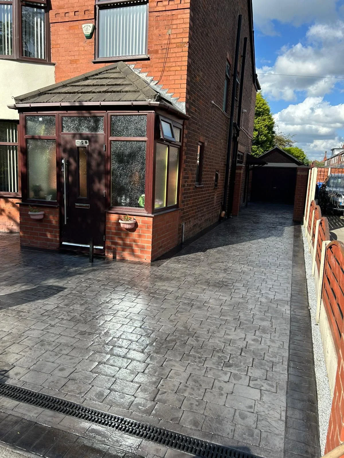 Newly completed pattern imprinted concrete driveway by L&R Surfacing