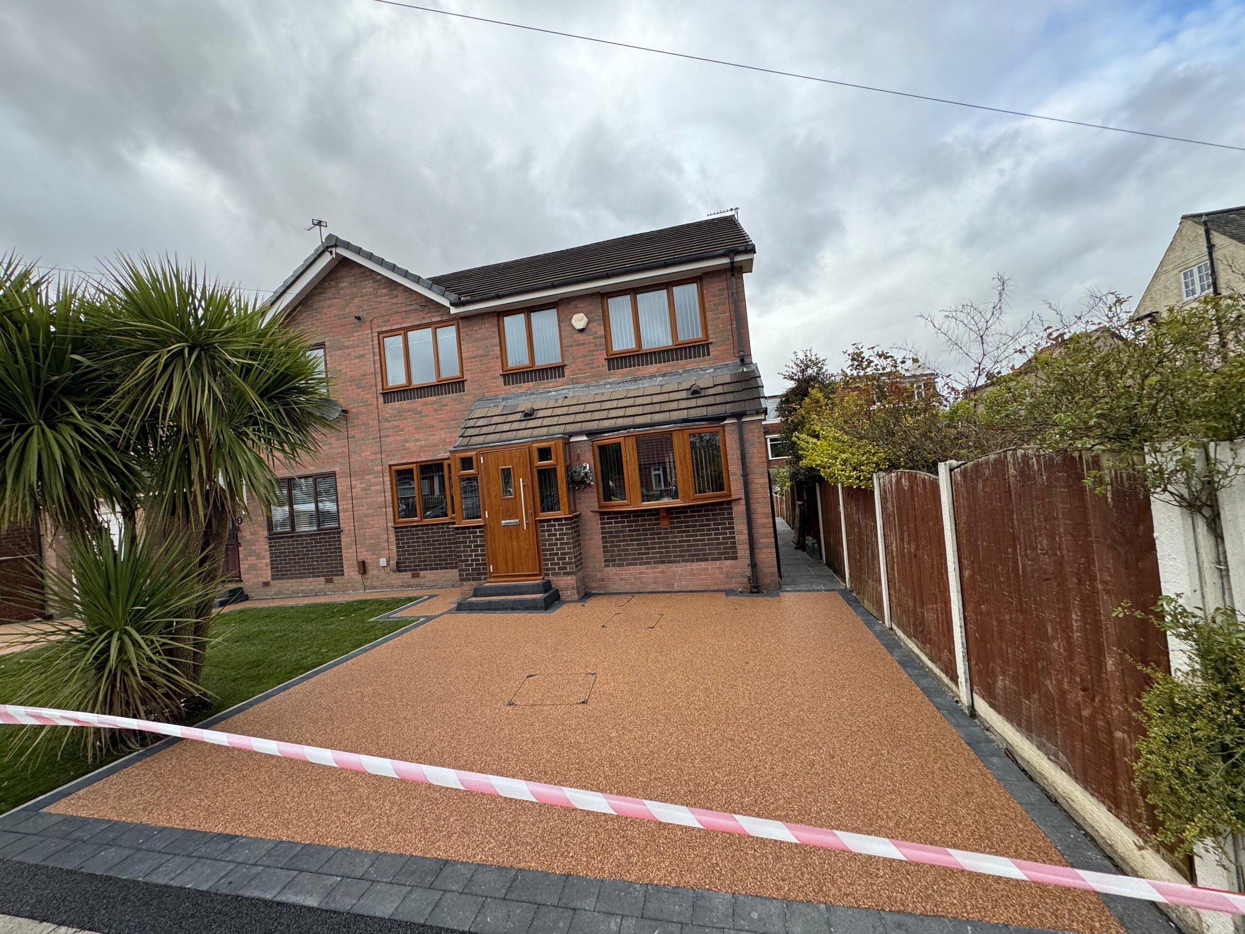 Permeable resin drive in Manchester draining rainwater naturally after rainfall